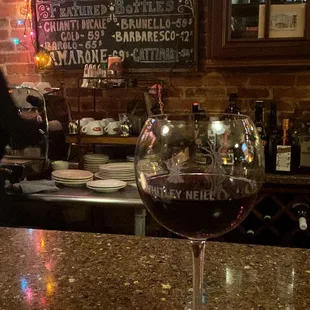 a glass of wine on a bar