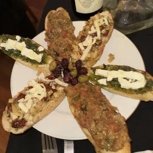 a plate of food with a bottle of wine in the background