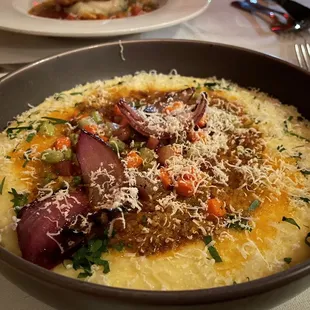 a bowl of grits and vegetables