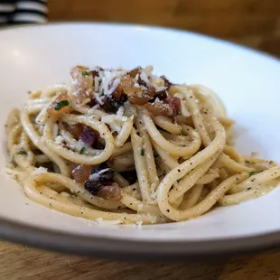 Bucatini. $24. Modified from the original version. No tomato sauce, but instead like a hybrid of carbonara and cacio e pepe, with pancetta.