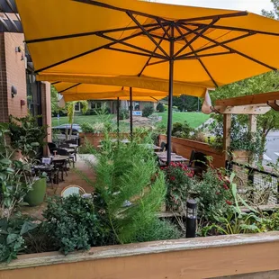 Outside. Side patio with umbrella-covered tables.