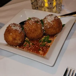 Risotto balls.  Creamy, chessy,  and crunchy coming with a pesto and tomato sauce.