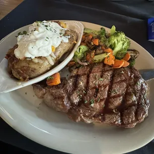 12oz Ribeye with loaded baked potato and roasted vegetables