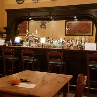 a bar with wooden tables and chairs