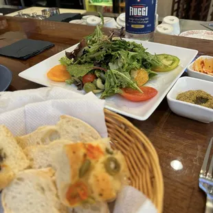 Bread basket with 2 different spreads and La Mista salad