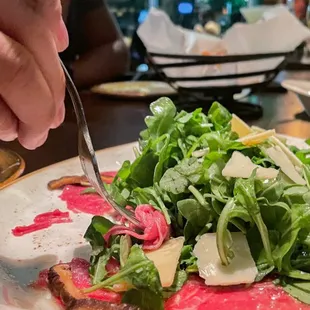Carpaccio Di Manzo* (17.95) Sliced raw filet mignon, white truffle, fried mushrooms, arugula, parmigiano, and lemon EVOO.