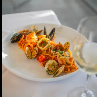 Linguine ai Frutti di Mare: fresh shrimp, mussels, clams, squid, octopus, and cherry tomatoes simmered in a rich tomato sauce.