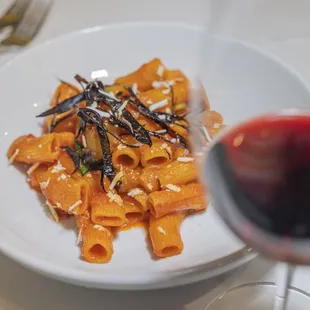 a plate of pasta and a glass of wine