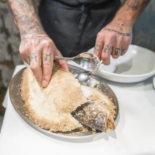 a chef preparing a fish dish