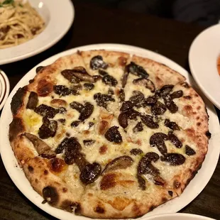 a pizza with olives and cheese