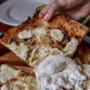 cacio e pepe pizza topped with burrata