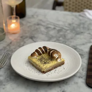 a white plate with a pastry on it