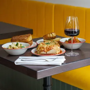 plates of food and a glass of wine