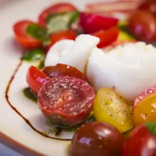 Heirloom tomatoes burrata, cheese, hazelnut romesco, sage vinaigrette served with focaccia