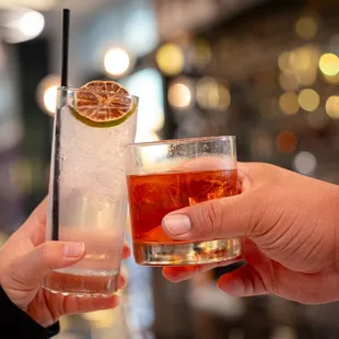 two people toasting with drinks