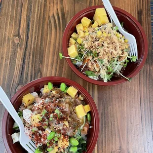 two bowls of food on a wooden table