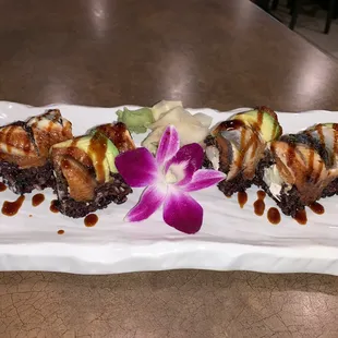 Imperial Roll with Black Rice garnished with a Flower.  Beautiful presentation.