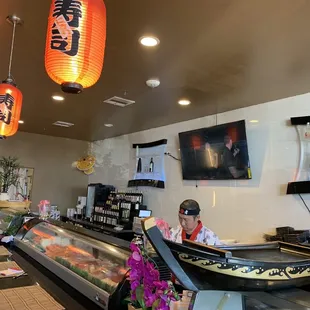 a sushi bar with a boat on the counter