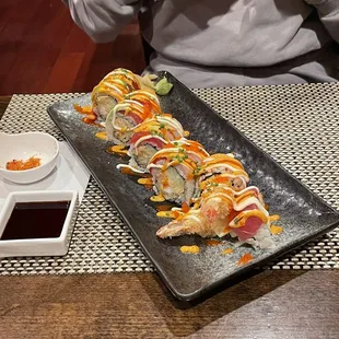 a person taking a picture of a sushi