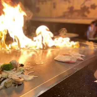 a person cooking food on a grill
