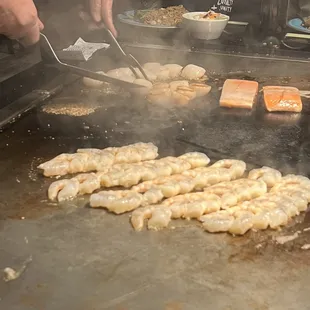 a person cooking food on a grill