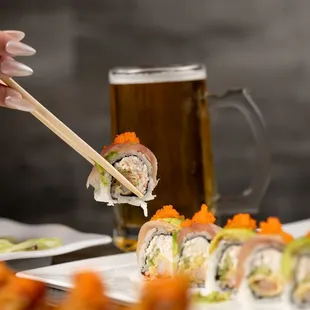 a person eating sushi with chopsticks