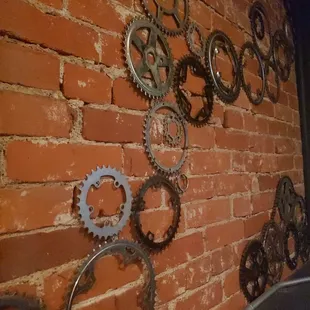 a brick wall with gears on it