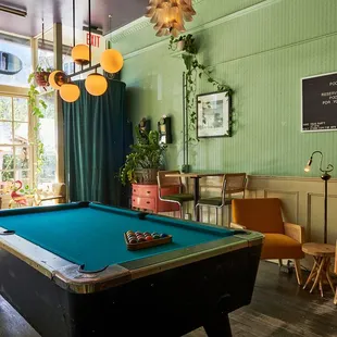 a pool table in a green room