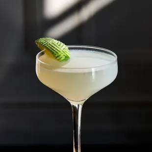 a close up of a cocktail in a coupe glass