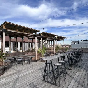 a deck with tables and chairs