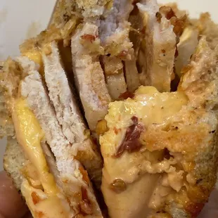 a person holding a sandwich