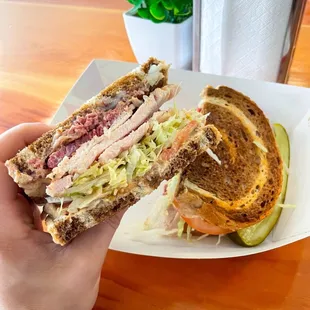 Pastrami &amp; mustard on rye with added turkey, lettuce, tomato, and onion