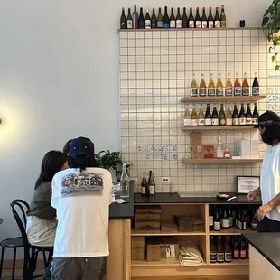 two people standing at the counter