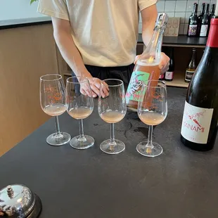 a man pouring wine into wine glasses