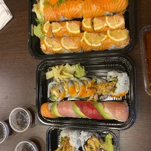 two trays of sushi on a table