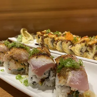 a plate of sushi and rolls