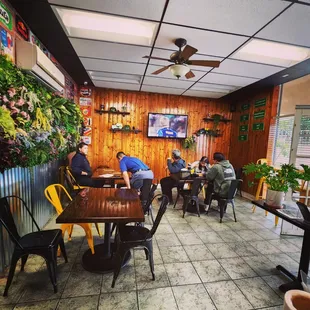 people sitting at tables in a restaurant