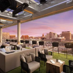 a view of the city from a rooftop lounge