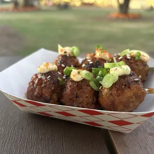 a plate of meatballs on a picnic table