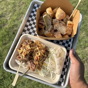 a person holding a tray of food