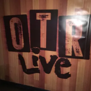 the word otr live on a wooden wall