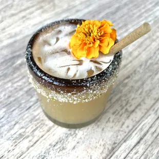 a drink with a flower on the rim