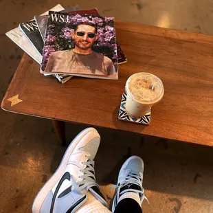 a person sitting at a table with a cup of coffee