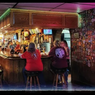 a group of people sitting at a bar