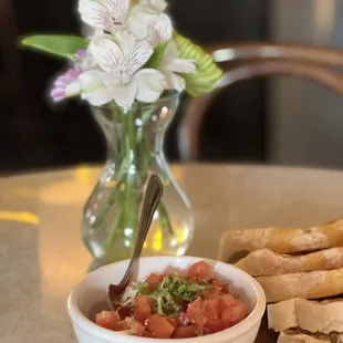 a bowl of salsa and bread