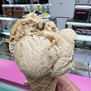 Salted caramel &amp; sugared pecan praline ice cream in a waffle cone