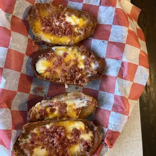 three stuffed potatoes with cheese and sauce