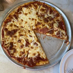 a pepperoni pizza on a pan