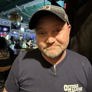 a man with a beard wearing a hat