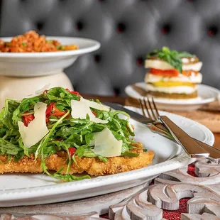 Chicken Milanese with Arugula Salad, Caprese Salad, and Rigatoni Bolognese